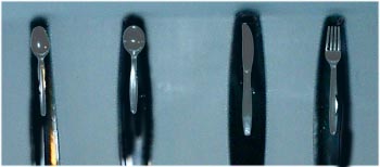 Teaspoon, soup spoon, knife and fork with small image of itself molded onto the handle