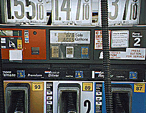 (gas pump with lots of stickers)